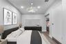 Bedroom featuring vaulted ceilings, wood-finish flooring, recessed lighting, and a decorative ceiling fixture