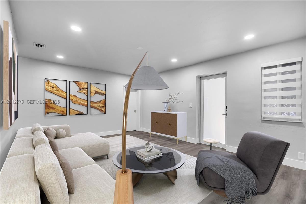 Living area featuring wood-finish flooring, recessed lighting, and a neutral color palette