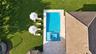Aerial perspective of a rectangular swimming pool with an integrated spa, featuring stone-finish decking, tile roofing, and a manicured lawn
