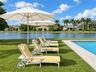 Swimming pool with natural stone decking and expansive waterfront lawn
