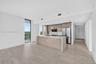 Neutral interior space featuring wood-finish tile flooring, recessed ceiling lighting, and floor-to-ceiling louvered bi-fold closet doors