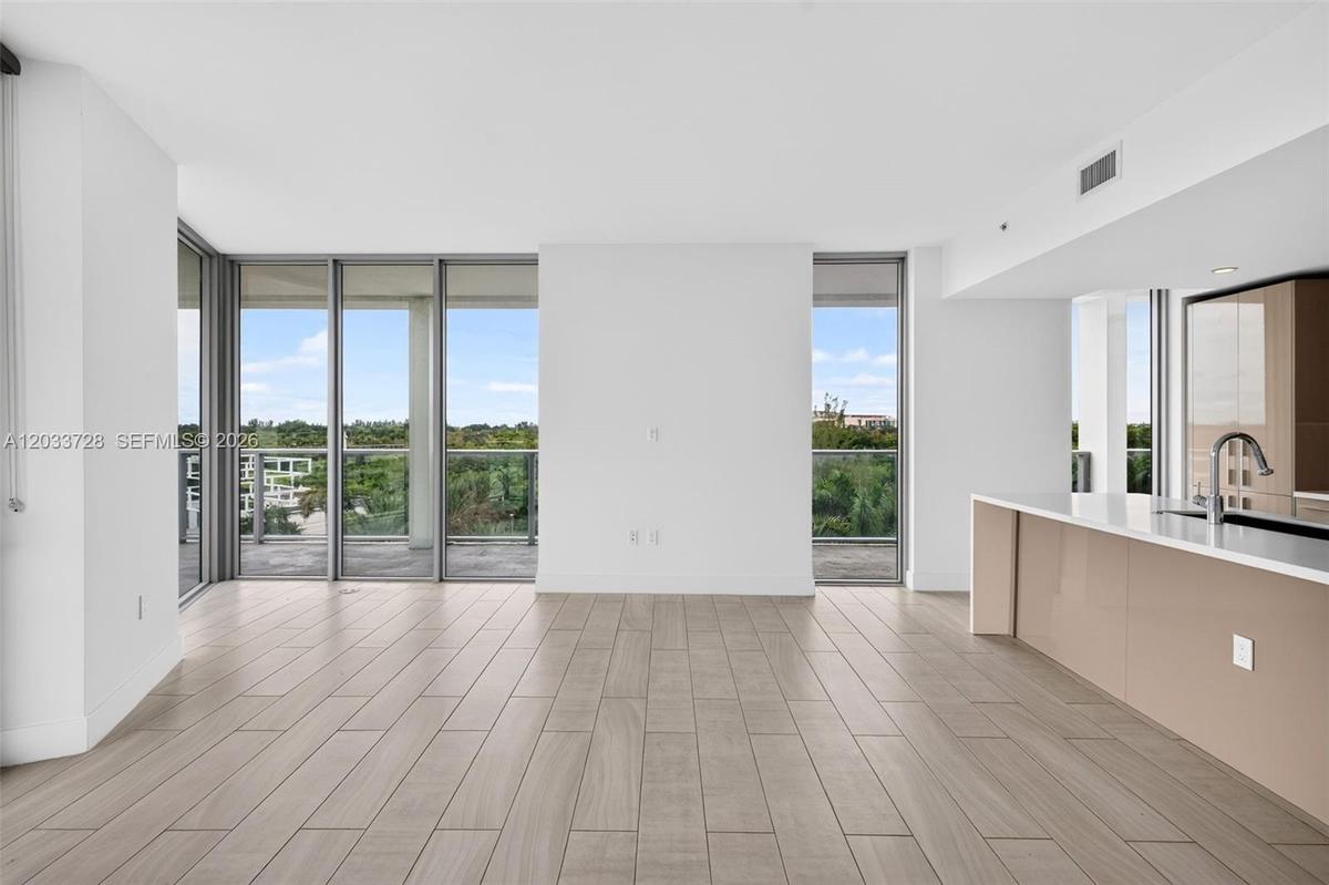 Minimalist interior featuring wood-finish flooring, recessed lighting, and a neutral color palette