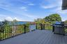 The expansive elevated deck features low-maintenance composite decking and offers breathtaking water views, creating an inviting setting for outdoor r