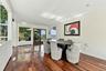 Dining room featuring hardwood flooring, recessed lighting, expansive glass windows, and glass-paneled double doors
