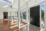Entryway featuring Hardwood flooring, high ceilings, recessed lighting, and expansive floor-to-ceiling windows