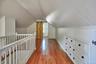 Bonus room with a barn door, dark wood-style flooring, recessed lighting, and lofted ceiling