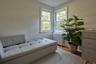 Sitting room with wood finished floors and radiator heating unit