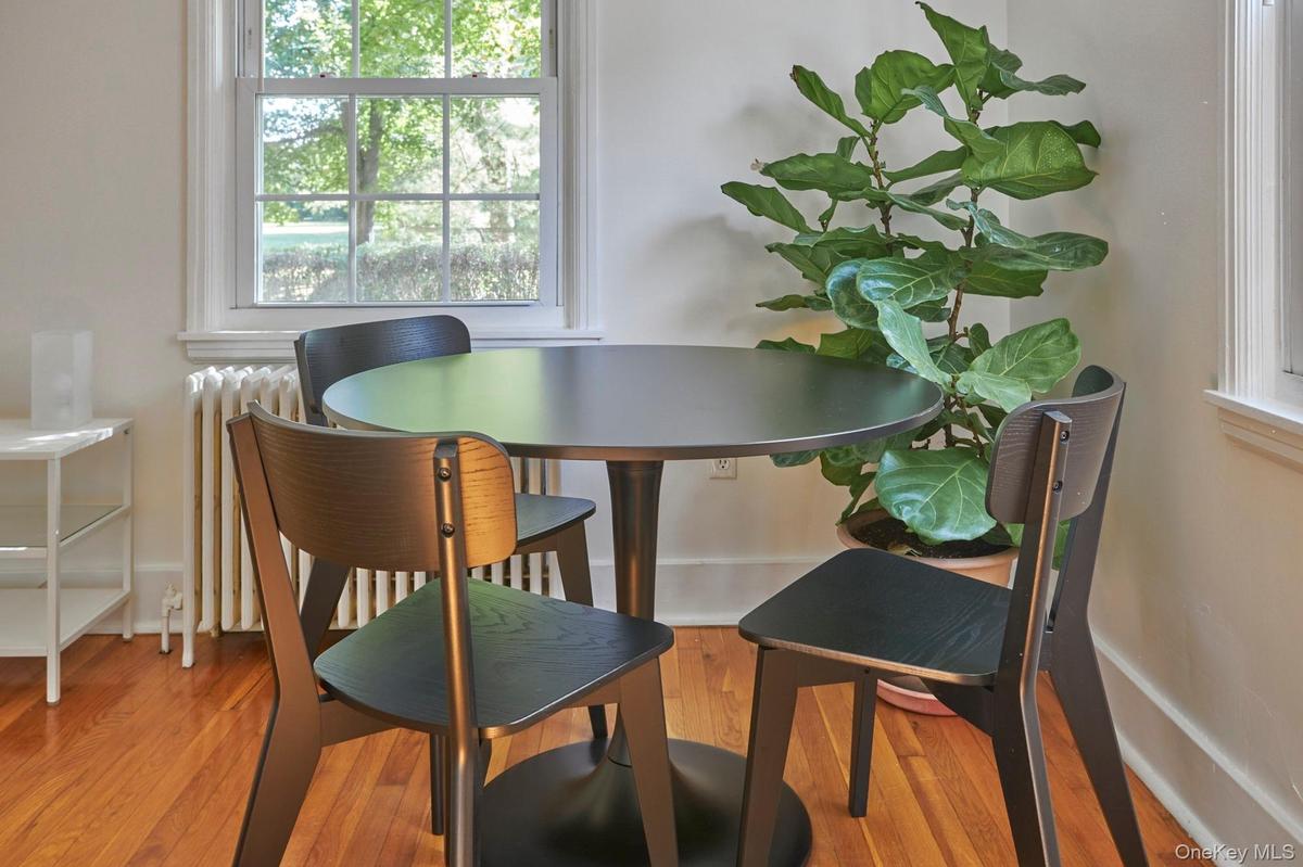 Dining area with radiator and wood finished floors