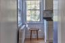Detailed view of radiator, decorative backsplash, and wood finished floors