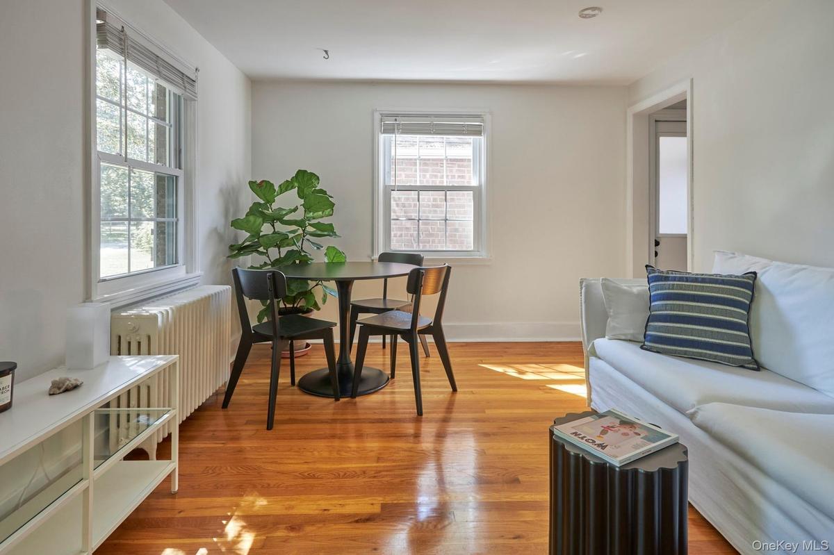 Living area featuring radiator heating unit and light wood-style floors