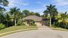 Mature tropical landscaping compliment this magnificent residence