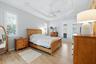Primary Suite provides direct access to the lanai, pool and Jacuzzi/spa
