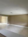 Neutral-toned interior featuring diagonal tile flooring and recessed ceiling lighting