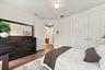 Neutral interior featuring wood-finish flooring, white paneled doors, and a central ceiling fan with integrated lighting