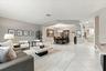 Living area featuring neutral wall tones, large-format tile flooring, recessed lighting, and a distinct architectural recessed ceiling detail