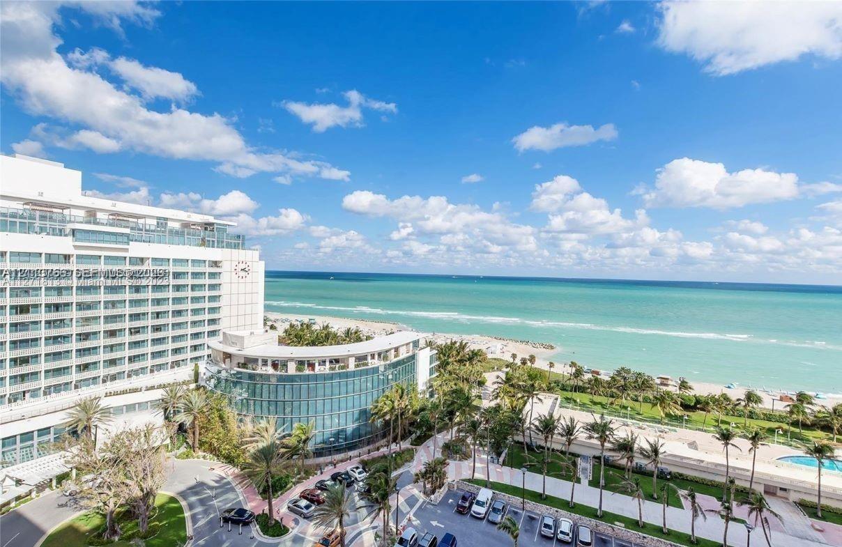 Exterior perspective of a high-rise structure featuring glass-paneled balconies, floor-to-ceiling windows, and oceanfront exposure to the Atlantic coa