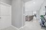 Entryway featuring large-format light-toned tile flooring, neutral wall paint, and recessed ceiling lighting
