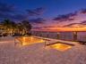 Paver patio featuring a swimming pool, integrated spa, and nautical-inspired wood post railing with rope accents