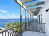 Covered balcony featuring a structural pergola, geometric metal railings, and tile flooring