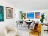 Open-concept interior featuring light-toned ceramic tile flooring and smooth-finish walls