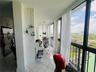 Floor-to-ceiling windows, tile flooring, and stainless steel kitchen appliance