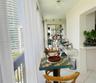 Enclosed balcony featuring large-format tile flooring, built-in recessed display shelving, and an expansive window wall
