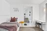 Wood-finish flooring, attached wall-mounted coat rack, and white interior finish