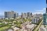 Panoramic cityscape featuring high-rise buildings, urban infrastructure, and coastal waterfront scenery