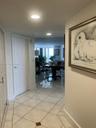 Hallway featuring large-format diagonal tile flooring with decorative stone accents and recessed ceiling lighting