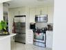 Kitchen featuring white cabinetry, stainless steel appliances, subway tile backsplash, white countertops, and tile flooring