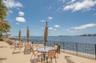 Waterfront paved terrace featuring a metal perimeter railing and direct water frontage