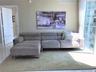 Floor-to-ceiling glass wall, white tile flooring, and neutral wall tones
