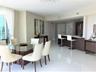 Open-concept living space featuring high-gloss tile flooring, crystal chandelier, kitchen with breakfast bar, dark-finish cabinetry, and floor-to-ceil