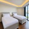 Tray ceiling with integrated cove lighting, wood-finish flooring, and floor-to-ceiling windows
