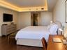 Interior space featuring recessed tray ceiling with integrated cove lighting, wood-finish flooring, and a solid-core interior door