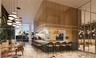Central bar featuring a stone-topped counter with teal tile cladding, a suspended gold-tone metal mesh canopy, floor-to-ceiling glass paneling, terraz