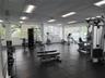 Fitness center featuring rubber flooring, drop ceiling with recessed lighting, and expansive windows