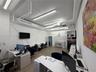 Industrial-style interior featuring high exposed ceilings, wood-finish flooring, linear LED lighting, and white finished walls
