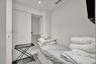 Built-in storage closet with sliding doors, recessed ceiling lighting, and hard-surface flooring