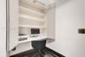Built-in cabinetry featuring recessed shelving and a integrated desk surface, paired with wood-finish flooring
