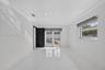 Interior room featuring large-format tile flooring, recessed lighting, crown molding, and double glass-paneled exterior doors with roller shades
