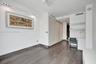 Wood-finish flooring, high-gloss built-in floor-to-ceiling cabinetry, recessed lighting, and a built-in workstation with integrated shelving and drawe