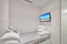 Wall-mounted flat-screen television and ceiling-mounted linear vent