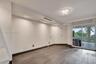 Interior space featuring wood-finish flooring, recessed ceiling lighting, a decorative flush-mount light fixture, and sliding glass doors with direct 