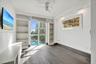 Wood-finish flooring, floor-to-ceiling windows, built-in shelving, ceiling fan, and recessed lighting