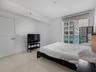 Floor-to-ceiling glass window, large-format tile flooring, neutral wall finish, and solid core interior door