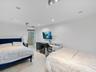 Recessed ceiling lighting, light-toned flooring, and wall-mounted television bracket