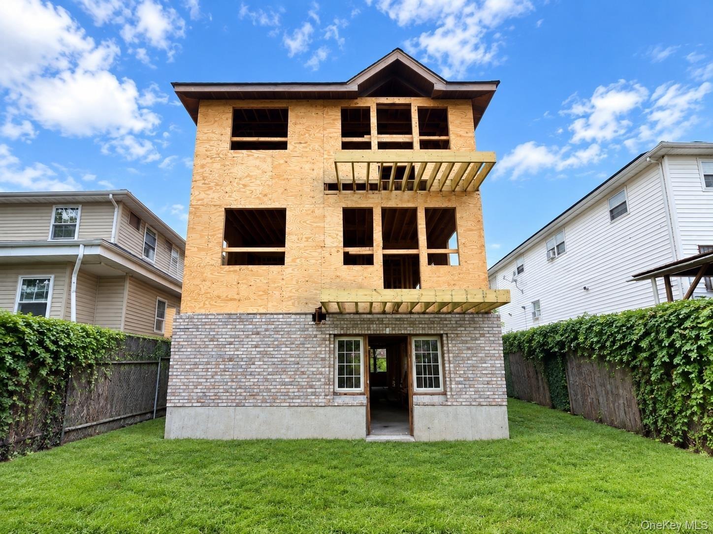 Front of the house showing 2 balconies and front door of basement