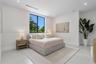 Neutral interior featuring high ceilings with recessed lighting, large window with black frame, and polished concrete flooring