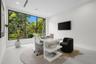 Large format floor-to-ceiling window with black trim, recessed lighting, and smooth-finish flooring
